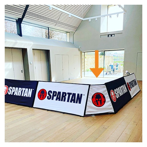 White and black branded rectangular pop-out corner banner units advertising Spartan