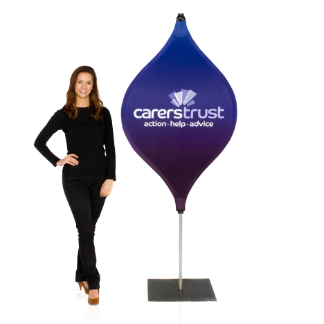 Woman wearing black clothing standing next to a branded pop-out lantern banner